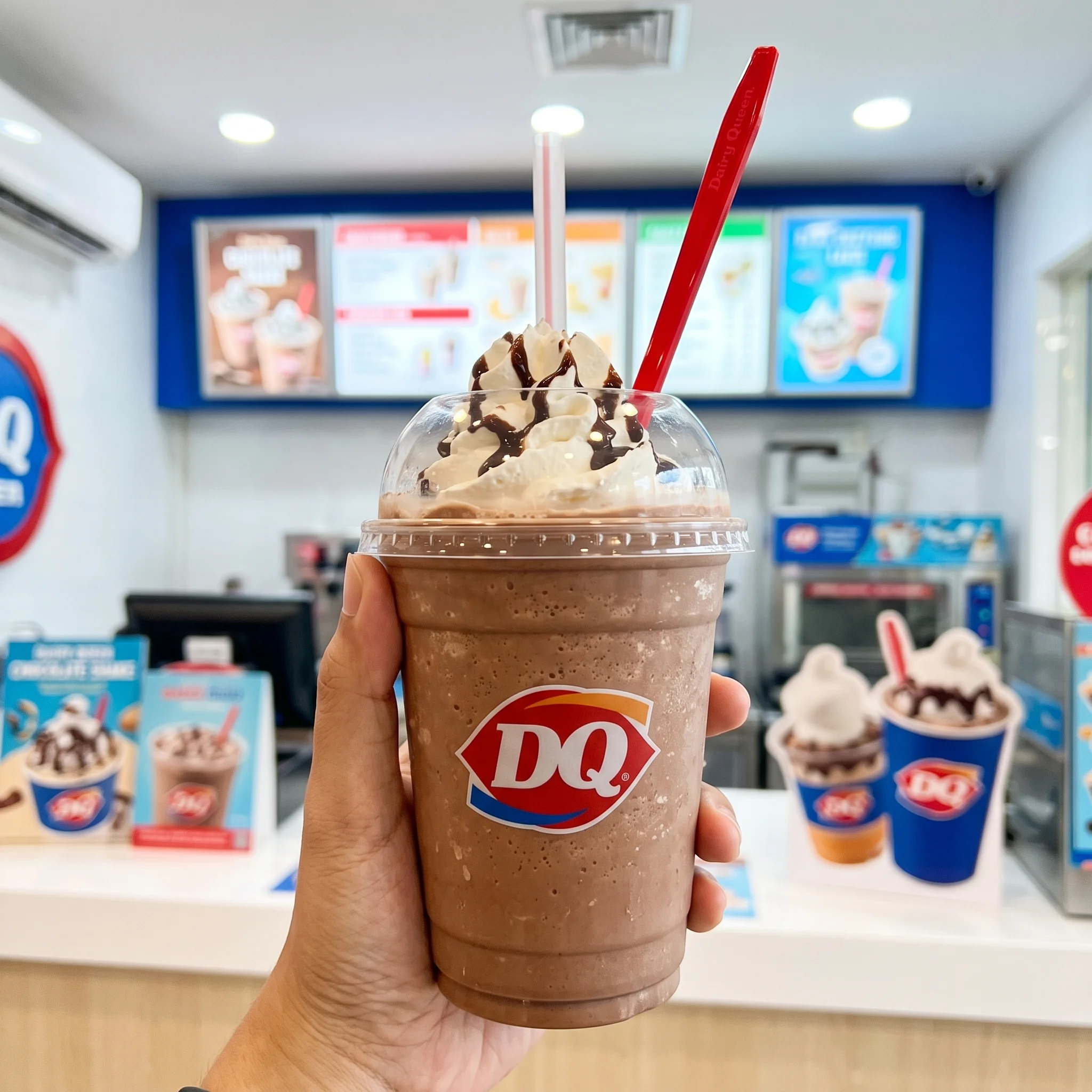Dairy Queen thick hand-spun chocolate shake topped with fluffy whipped cream and rich chocolate drizzle